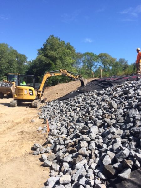 Applying rock to the back hill Applying rock to the back hill